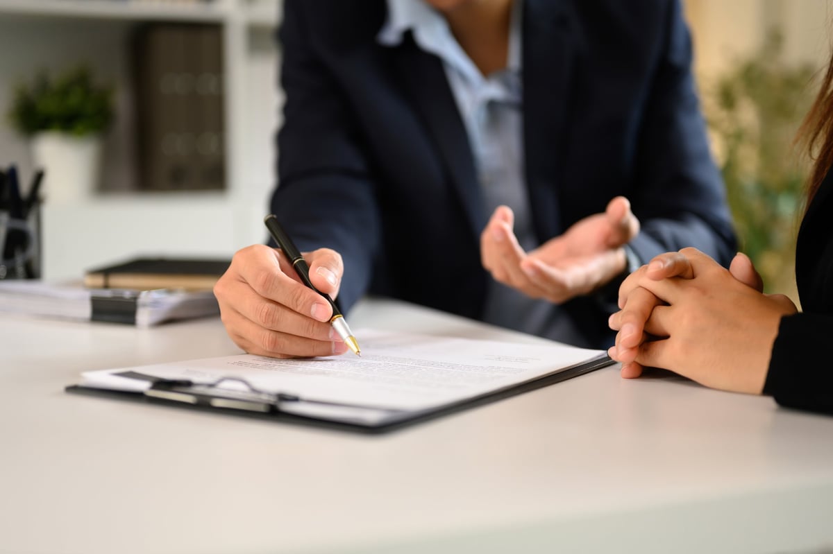 Attorney reviewing legal documents at a desk in a modern law office